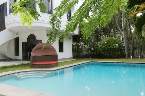 a swimming pool in front of a building at Last island in Ho Chi Minh City