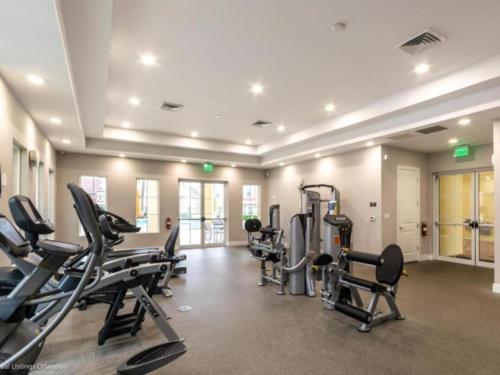 a gym with treadmills and cardio equipment in a building at Magical 4BR Escape - Pet-Friendly, 9 Min to Disney in Orlando