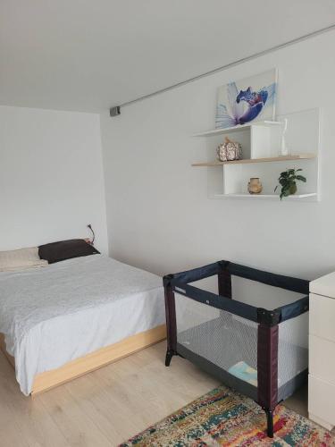 a bedroom with a bed and shelves on the wall at WHITE APARTMENTS free parking self check-inn in Riga