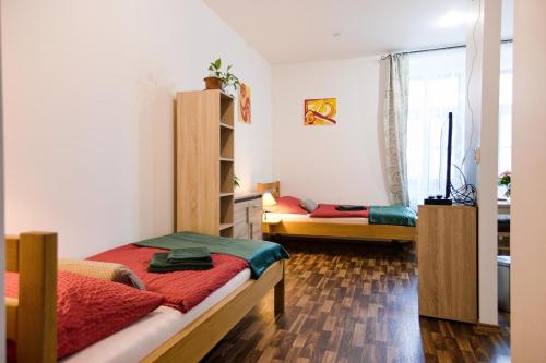 a bedroom with two beds and a window at Penzion a wellness U Třeboňské madony in Třeboň