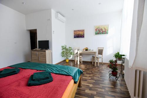a bedroom with a bed and a table in a room at Penzion a wellness U Třeboňské madony in Třeboň
