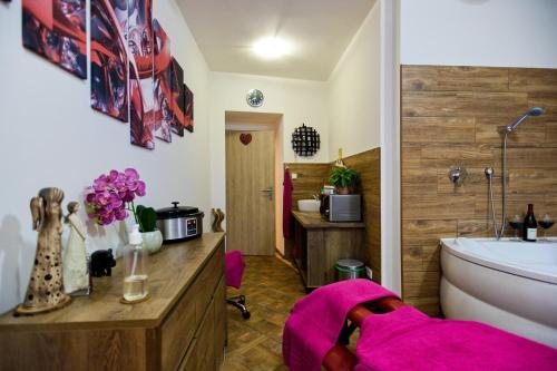 a bathroom with a tub and a toilet and a sink at Penzion a wellness U Třeboňské madony in Třeboň
