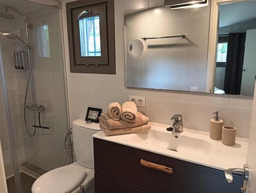 a bathroom with a sink and a toilet and a mirror at La Casita - Boutique Retreat Barcelona Coast Sea View in Sant Andreu de Llavaneres