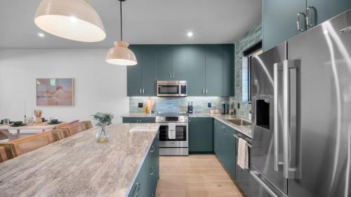 a kitchen with blue cabinets and a counter top at Montclair at Zion in Springdale