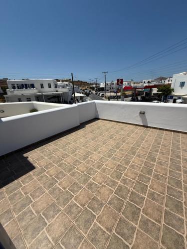 a balcony with a tile floor on a roof at Naousa house in Naousa