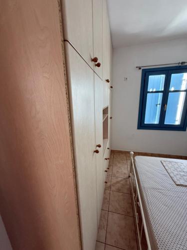 a room with a bed and a window at Naousa house in Naousa