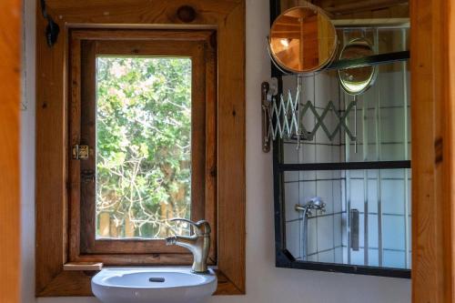 a bathroom with a sink and a window at Tinyhouse Hexagonal in Organic Farm in Sintra