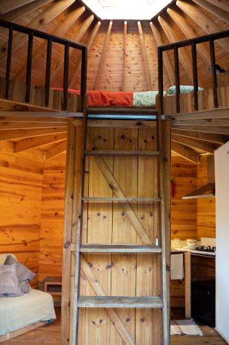 a room with two bunk beds in a wooden wall at Tinyhouse Hexagonal in Organic Farm in Sintra