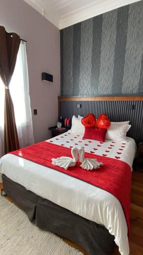 a bedroom with a large bed with red pillows at La Blanca Hotel in Viña del Mar
