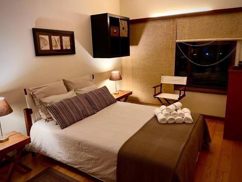 a bedroom with a large bed with two candles on it at Garrett by the Sea in Vila do Conde