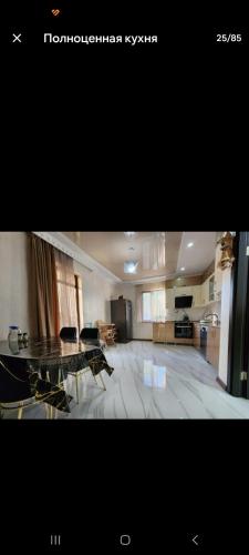 a large living room with a table and a kitchen at mado house in Chakvi