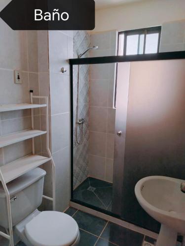 a bathroom with a shower and a toilet and a sink at Zona Premium - Amplio Dep in Cochabamba