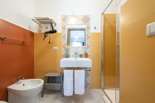 a bathroom with a sink and a mirror at Affittacamere Marizzola in Cala Gonone