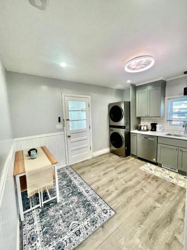 an empty kitchen with a table and a sink at Cozy 3-Beds in 2-Bedrooms Apartment Near Quincy Adams in Quincy