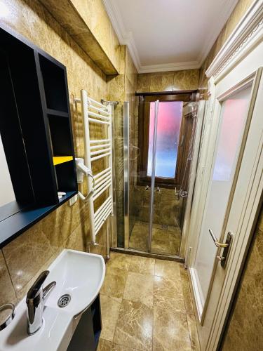 a bathroom with a sink and a shower at LA MAİSON FAMILY Hotel in Istanbul