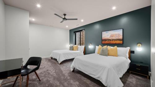 a hotel room with two beds and a desk at Montclair at Zion in Springdale