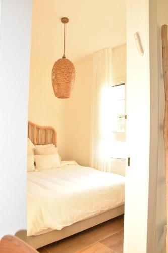 a bedroom with a bed and a pendant light at כרמי הכפר in Kefar Barukh