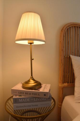 a lamp sitting on top of three books on a table at כרמי הכפר in Kefar Barukh