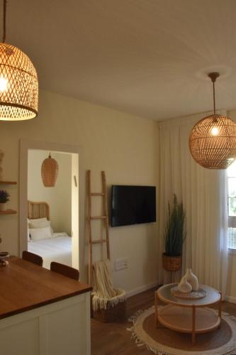 a living room with a room with a bed and a table at כרמי הכפר in Kefar Barukh