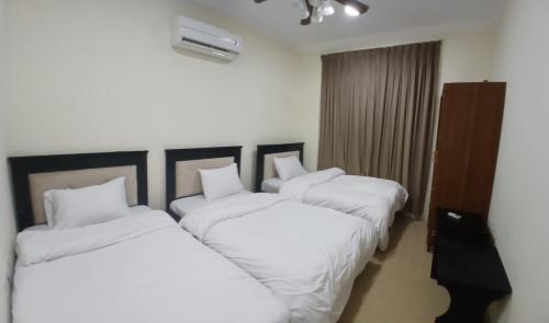 En eller flere senge i et værelse på زهره الوادي 2 للشقق المفروشة