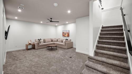 a living room with a couch and a staircase at Montclair at Zion in Springdale