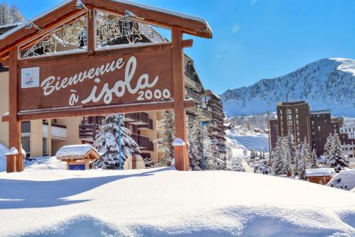 a sign at the entrance to a hotel in the snow at Résidence Les Terrasses D'Isola - Isola 2000 in Isola