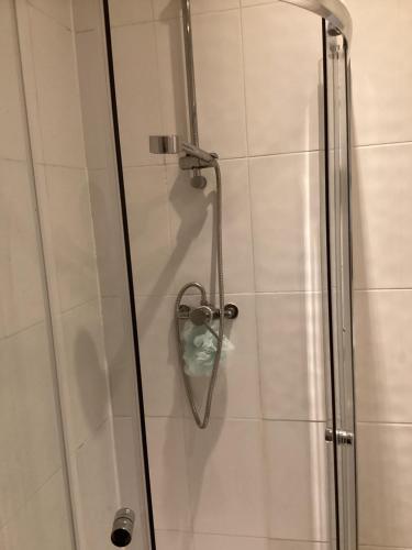 a shower in a bathroom with a glass door at Large Family Home, Pet Friendly, 4 Bed 2 Bath House, Sleeps 10, Free Wi-Fi, Free Parking in Dagenham Dock