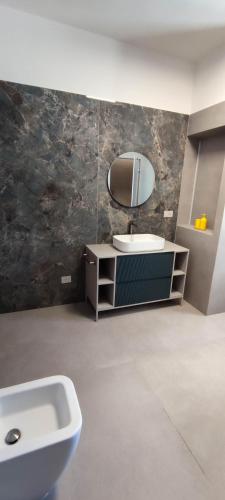 a bathroom with a sink and a mirror at Villeriunite - Villa Dalia in Baia Verde