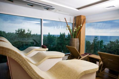 a living room with chairs and a large window at Hotel Bryza Resort & Spa in Jurata