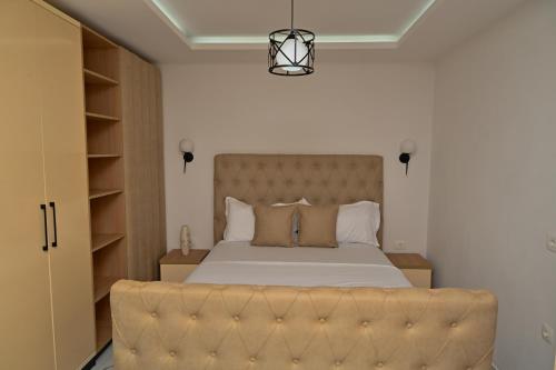 a bedroom with a large bed with a large headboard at Stars Five Stay in Ulcinj
