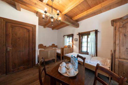 a dining room with a table and a bedroom at Polana Sosny in Niedzica Zamek