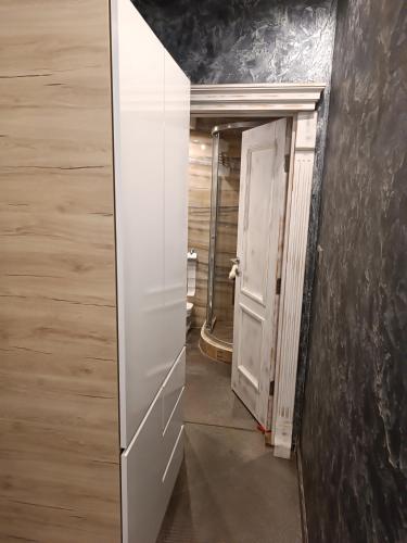 a mirror in a room with a door and a hallway at Martina 1 in Budva