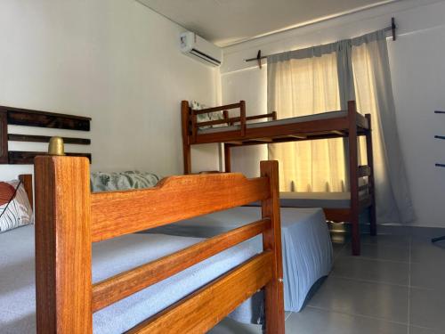 a bedroom with three bunk beds in a room at Casa de Pedras in Prado