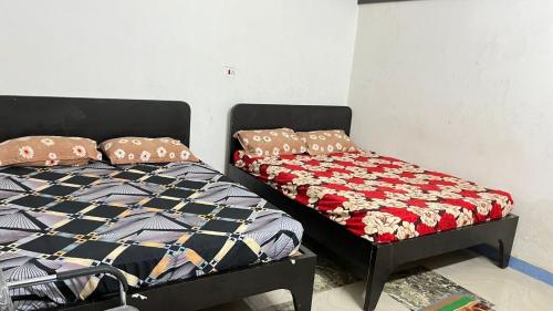a bedroom with a bed and a comforter at Shree Sidhi Vinayak Guest House in Gaya