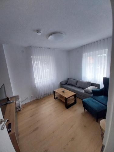 a living room with a couch and a coffee table at Sunny Donau in Donaueschingen