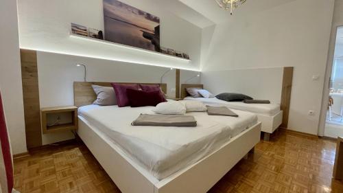 two large beds in a room with at Apartments Villa Agatha in Sveti Filip i Jakov