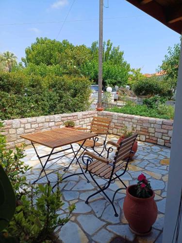 a picnic table and chairs on a stone patio at Aggelikis house in Methoni