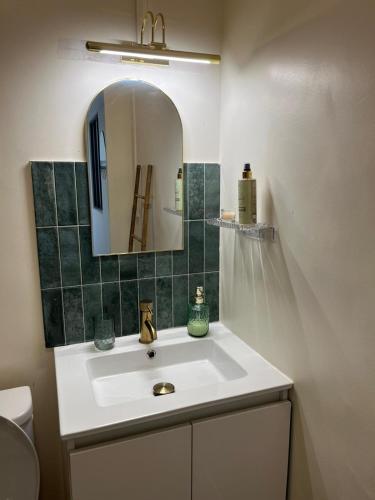 a bathroom with a sink and a mirror at Apartment in Noailles Marseille in Marseille