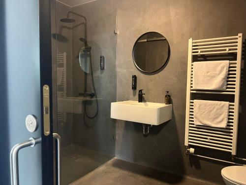 a bathroom with a sink and a shower and a mirror at Hótel Bifröst in Bifrost