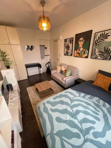 a living room with a bed and a couch at Charmant studio deux min métro in Aubervilliers