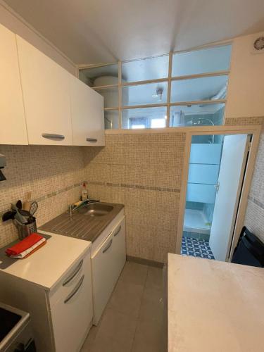 a kitchen with a sink and a counter top at Charmant studio deux min métro in Aubervilliers