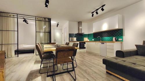 a kitchen and living room with a table and a couch at GVC New Gudauri Atrium in Gudauri