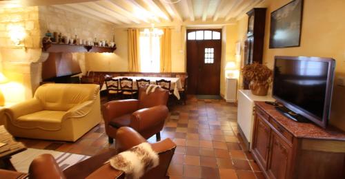 a living room with a television and a dining room at Domaine Garmidou in Lucq-de-Béarn