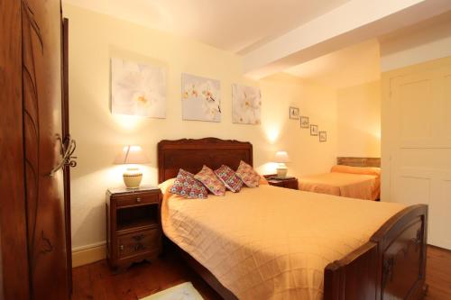 a bedroom with a bed and two tables with lamps at Domaine Garmidou in Lucq-de-Béarn