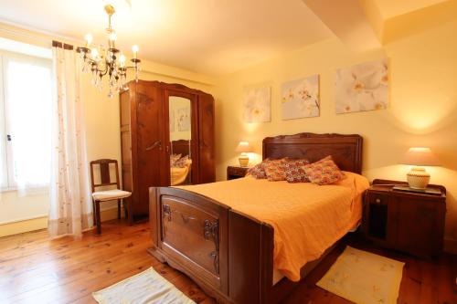 a bedroom with a bed and a chandelier at Domaine Garmidou in Lucq-de-Béarn
