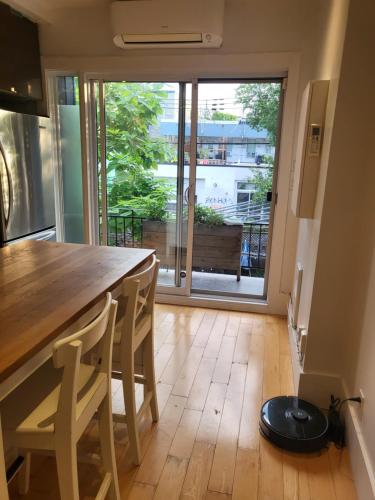 a kitchen with a table and a view of a balcony at Super appartement proche metro in Montréal
