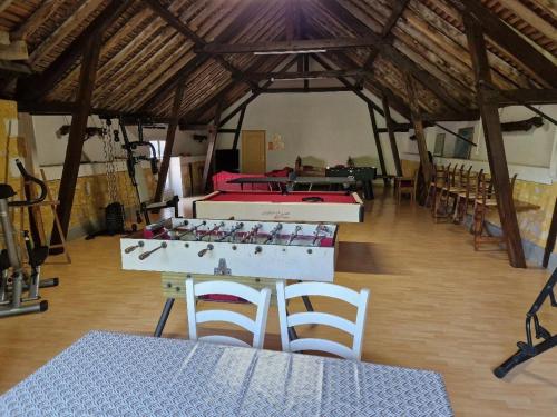 a room with two tables and chairs in a building at Domaine Garmidou in Lucq-de-Béarn