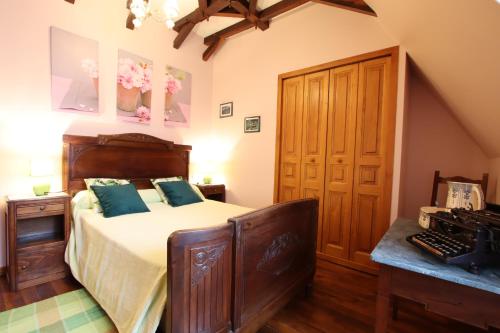 a bedroom with a large bed and a wooden cabinet at Domaine Garmidou in Lucq-de-Béarn