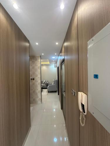 a hallway with a phone in a room at نزل جنى 2 in Dammam