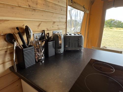 a kitchen counter with knives and utensils on it at The Paddock in Bredon